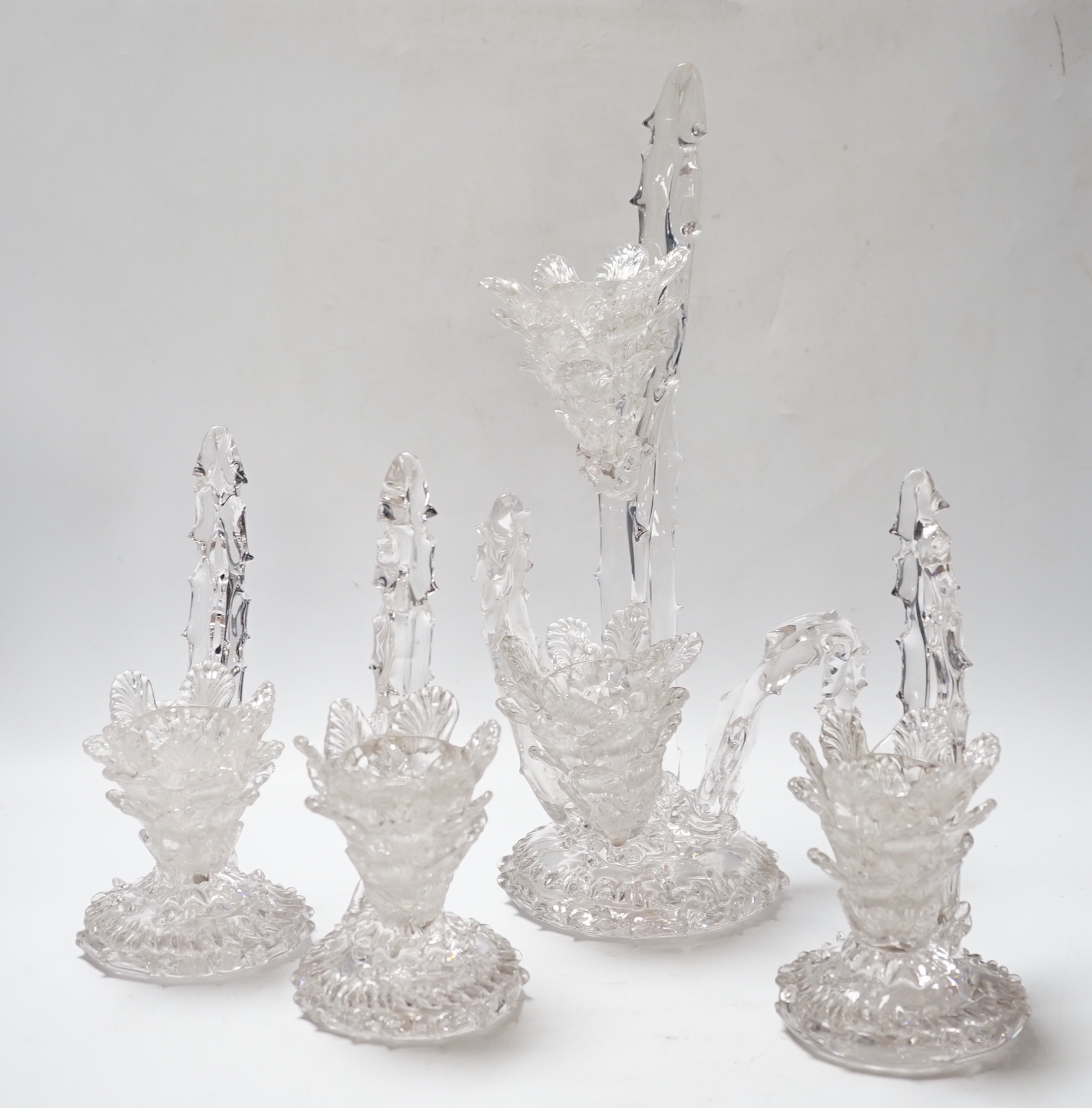 A set of four glass stylistic floral candlesticks, (one double holder the other three single holder), tallest 33cm high
